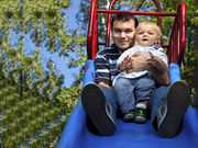 Young children injured going down a slide on someone's lap most commonly experience leg fractures
