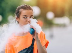 Pretty young hipster woman vape ecig