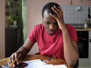 Most Cancer Centers Do Not Disclose Payer-Specific Prices Young anxious worrying african american man looks desperately to bills