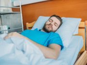 Weight Loss and Lifestyle Program Cuts Severity of Sleep Apnea young sick man sleeping on hospital bed at ward