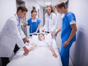 Emergency Residents Lacking in Rural Areas of United States Doctors pushing emergency stretcher bed in corridor