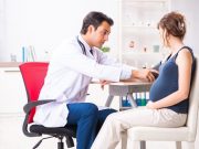 Formal Training in Cardio-Obstetrics Uncommon Young doctor checking pregnant woman's blood pressure